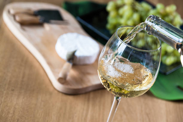 Pouring Sauvignon Blanc with goat cheese