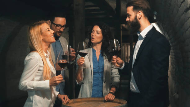 colleagues tasting wine together in a wine cellar